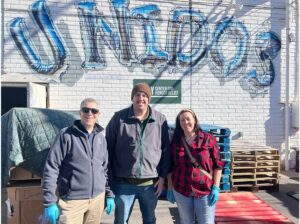 Blog - Team Smiling and Standing for a Photo for their Volunteer Day